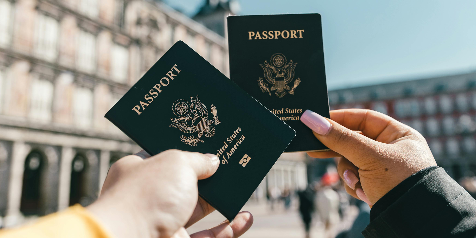 Two people holding passports