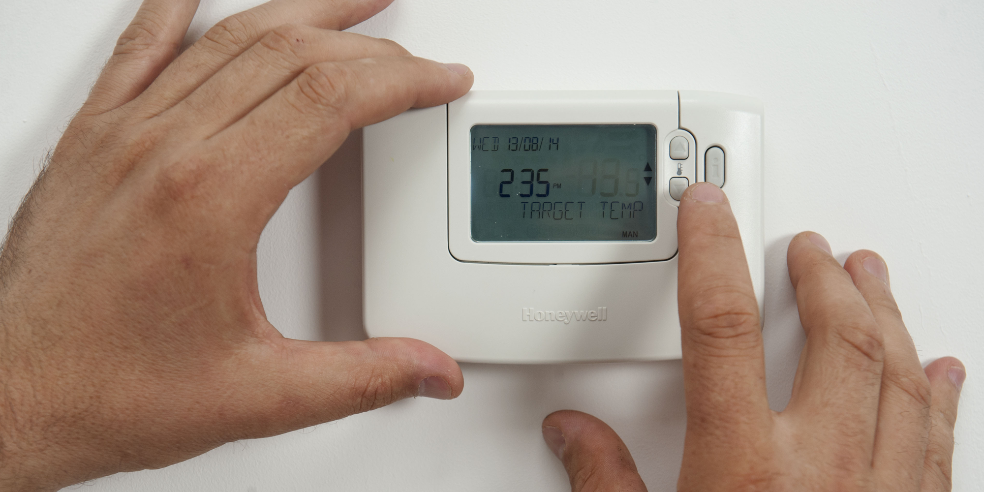 Person adjusting thermostat