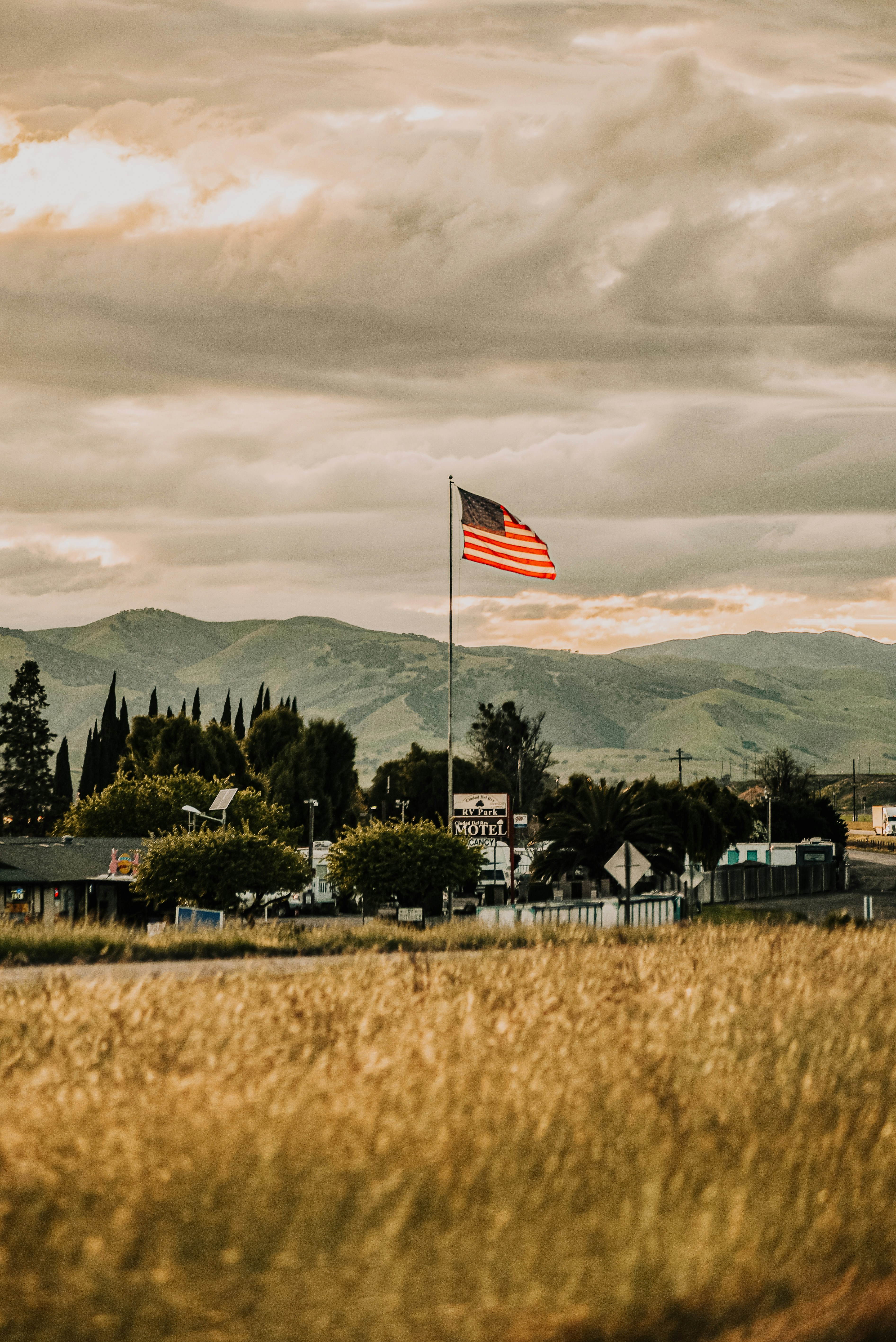 American flag flying above a rural field