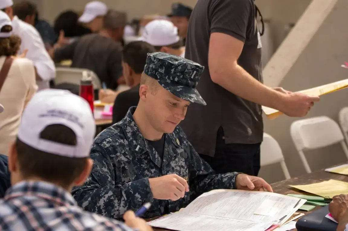 Military person filling out paper form