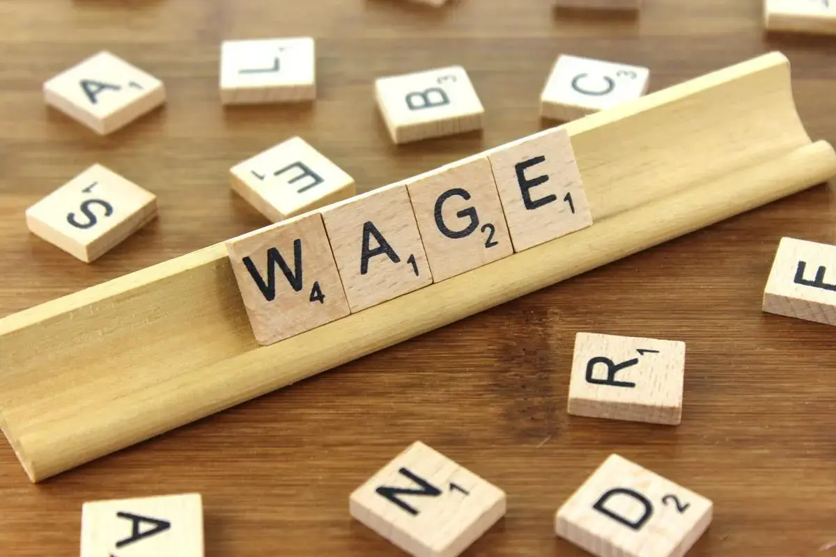 Scrabble tiles spelling the word wage